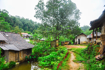 Fototapeta na wymiar Rural mountain little village with river and typical Indonesian countryside houses on the west Java, Indonesia