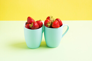 Red strawberries in blue circles on a light green and lime background, horizontal orientation, side view.