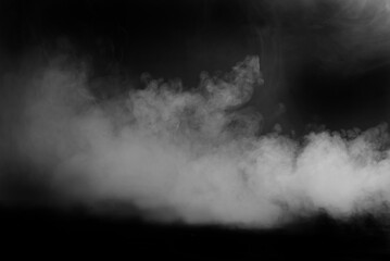White smoke on a black background. The texture of scattered smoke. Blank for design. Layout for collages.