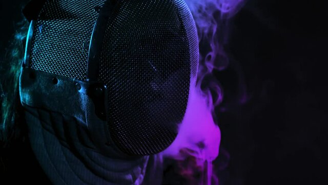 sci-fi colourful Smoke slowly exhaled through a fencing mask  