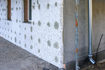 the facade of the house, which is covered with thermal insulation boards