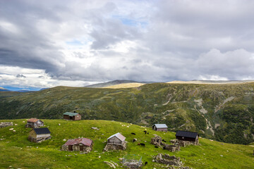 clouds above the wooden huts at the mountain road near Aurlandsvangen in Norway