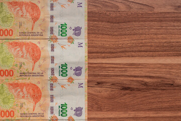 Argentinian cash money "pesos" on wooden background