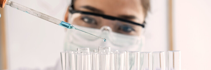 Scientist in lab working in laboratory using equipment for research