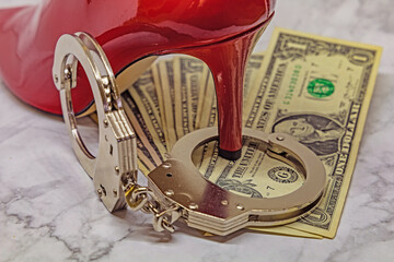 red high heels, money and handcuffs