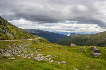 clouds above the wooden huts at the mountain road near Aurlandsvangen in Norway