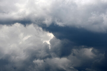 Naklejka na ściany i meble Dark and white fluffy clouds in the sky
