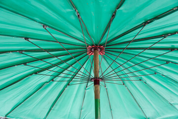 Beach umbrella mechanism. green beach umbrella