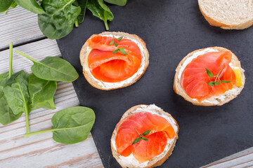 Salmon mini sandwiches on black slate board