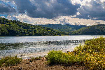 Fototapeta premium Lake on mountain, cloudy spring day. Vrutci lake on Zlatibor mountain in Serbia