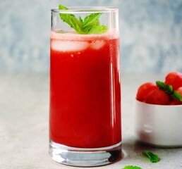 Refreshing watermelon juice in a tall glass with mint garnish,selective focus