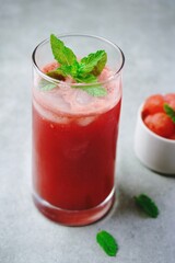 Refreshing watermelon juice in a tall glass with mint garnish,selective focus
