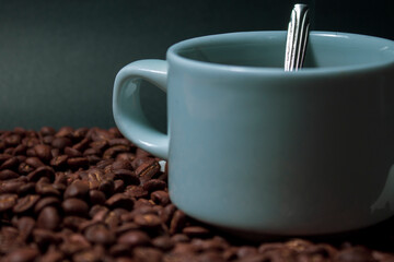 Coffee cup and coffee beans on black background