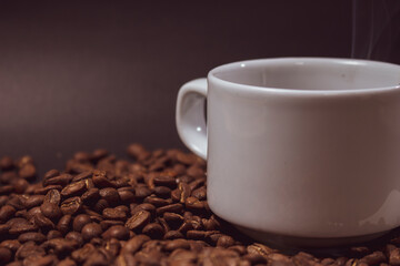 Coffee cup and coffee beans on black background