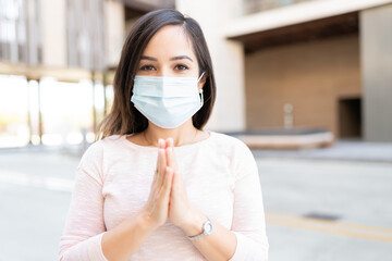 Woman With Hands Clasped Wearing Face Mask