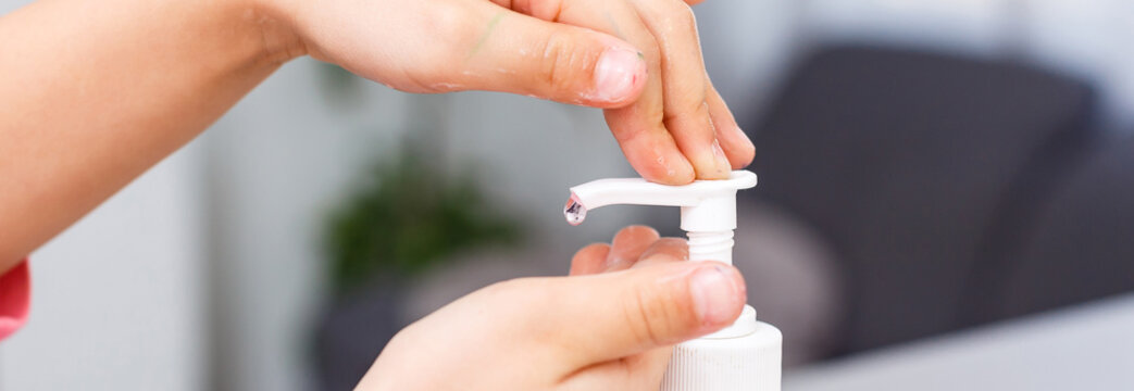 Little Girl Applying Antibacterial Antiseptic Gel On Hands Anti Bacteria Viruses In Studio On White Background. Baby Epidemic Protection, Close-up