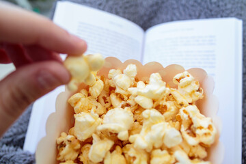 Eating popcorns while reading a book