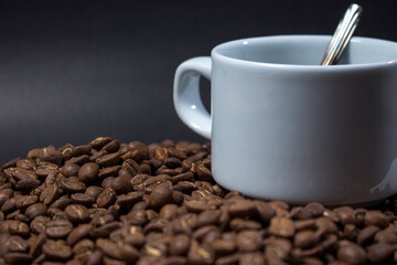 Coffee cup and coffee beans on black background
