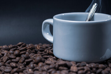 Coffee cup and coffee beans on black background