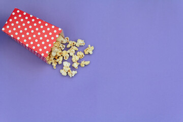 Red box with popcorns on purple background