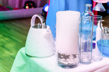 The flask is full of steam and liquid nitrogen in the children's laboratory. A set of containers and tools for scientific experiments