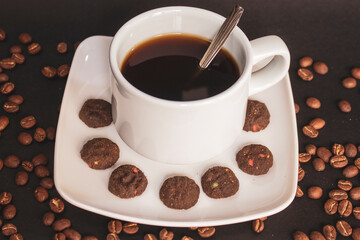 Coffee cup and coffee beans on black background