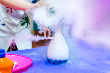 A flask of steam and white smoke in a chemical laboratory. A set of containers and tools for scientific experiments.