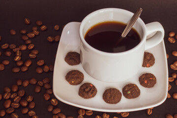 Coffee cup and coffee beans on black background