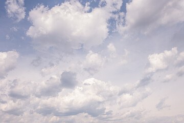 background of white fluffy clouds on a bright blue sky
