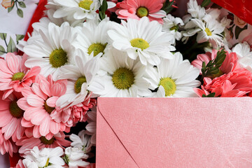 postcard mockup. floral background. bouquet of flowers and an envelope with place for text. bouquet of daisies