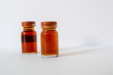 hand with gloves holding a medicine bottle