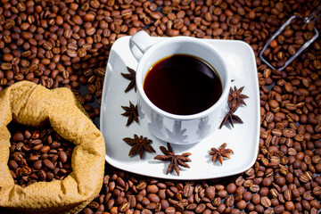 Coffee cup and coffee beans on black background