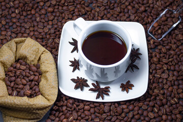Coffee cup and coffee beans on black background