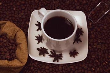 Coffee cup and coffee beans on black background