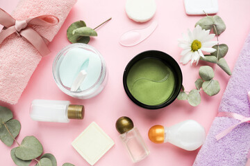 Obraz na płótnie Canvas spa theme. face mask, set of towels, cosmetics and eucalyptus leaves