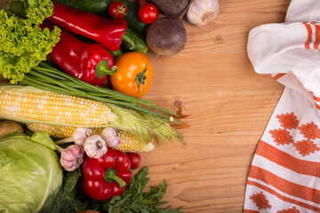 Assortment of fresh raw vegetables on a wooden table. Healthy food Top view background with empty...