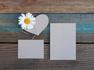 mock up. daisy and gray cards on a wood-aged background. option card or postcard