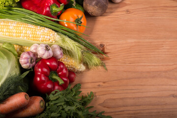 Assortment of fresh raw vegetables on a wooden table. Healthy food Top view background with empty space.