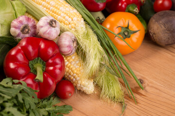 Assortment of fresh raw vegetables on a wooden table. Healthy food Top view background with empty space.