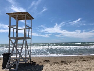 A white lifeguard tower on the beach .