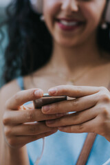Close-up of teenage girl using smartphone and listening to music