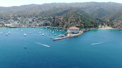 Aerial view of Catalina Bay and Avalon harbor with sailboats, fishing boats and yachts moored in calm bay, famous tourist attraction in Santa Catalina Island, Southern California