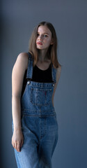 young girl in denim overalls, studio shooting