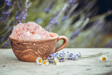 Obraz na płótnie Canvas Selective focus old vintage ceramic cup of tea with flowers. Old rustic wooden table ware.