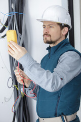a serious electrician sets cables