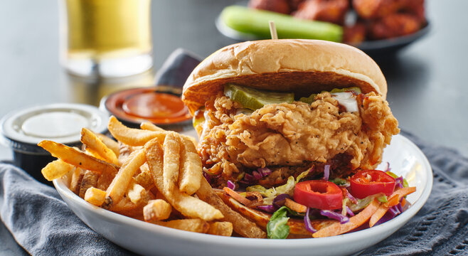 fried chicken sandwich with coleslaw and french fries