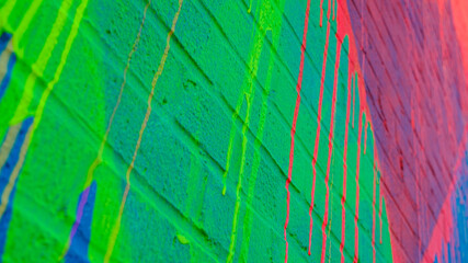 Bright, colorful paint on a brick wall