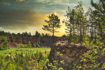 Rocky hill. View of sandstone, remains of a mine. Rocky hill covered with trees and vegetation.