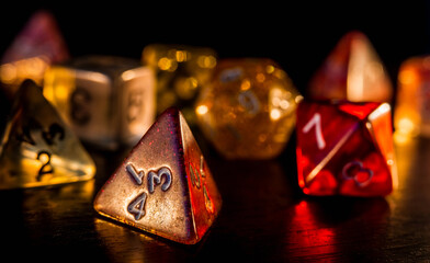 Colorful and shiny role playing dices close-up on a dark background. RPG or board game concept.