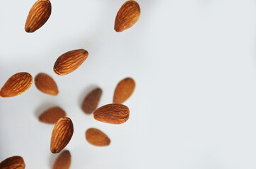 almonds fly on a white background. Composition of nuts flat lay almonds on white background. Concepts about decoration, healthy eating and food background.